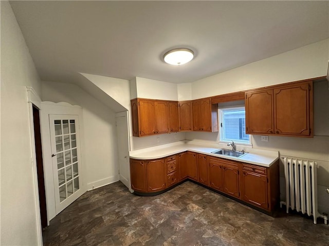 kitchen featuring radiator heating unit and sink