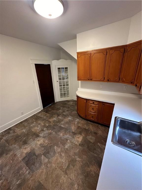 kitchen featuring lofted ceiling and sink