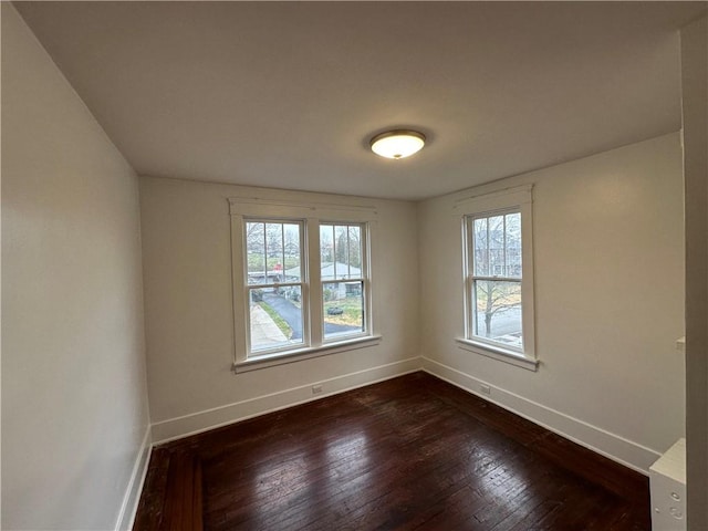 spare room featuring dark hardwood / wood-style floors