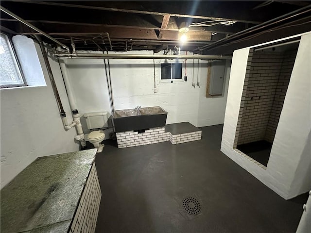 basement with sink and electric panel