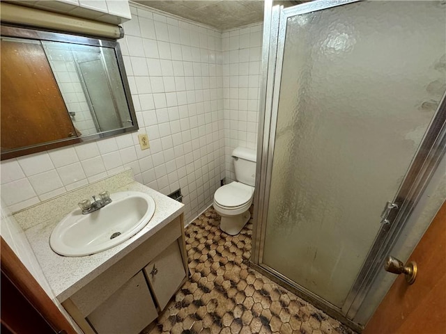 bathroom with tasteful backsplash, walk in shower, vanity, tile walls, and toilet