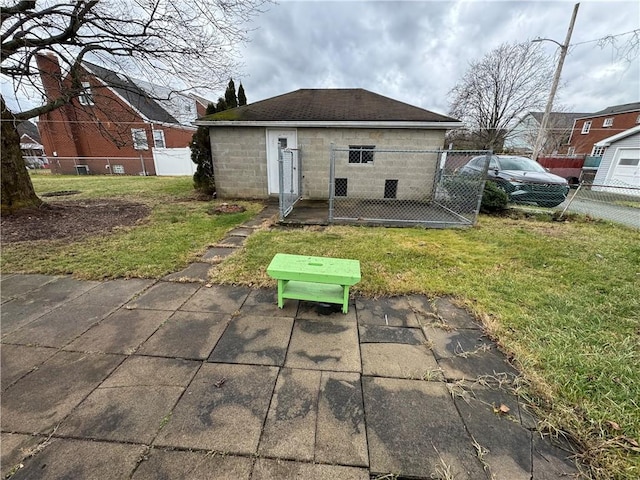 rear view of property with a lawn and a patio area