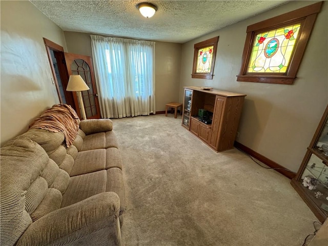 carpeted living room featuring a textured ceiling