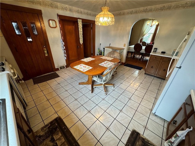 dining room with an inviting chandelier and ornamental molding