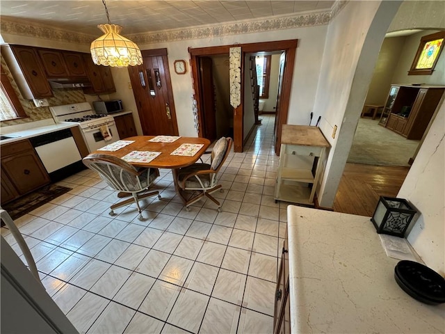 tiled dining area featuring a notable chandelier