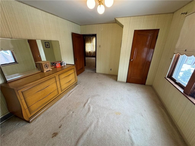 bedroom with light colored carpet and a closet