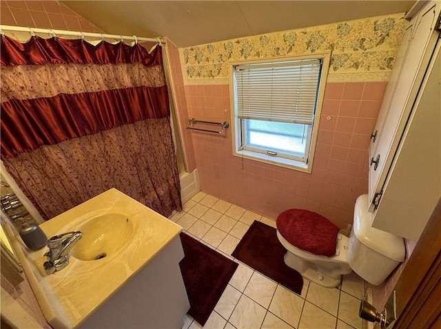 full bathroom with vanity, shower / bath combo with shower curtain, tile walls, tile patterned flooring, and toilet