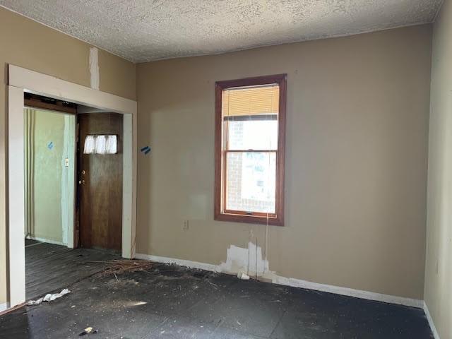 spare room with a textured ceiling