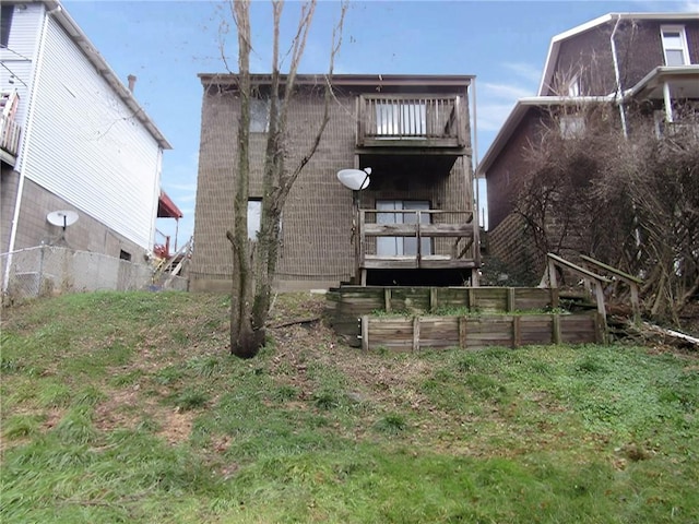 back of property featuring a balcony