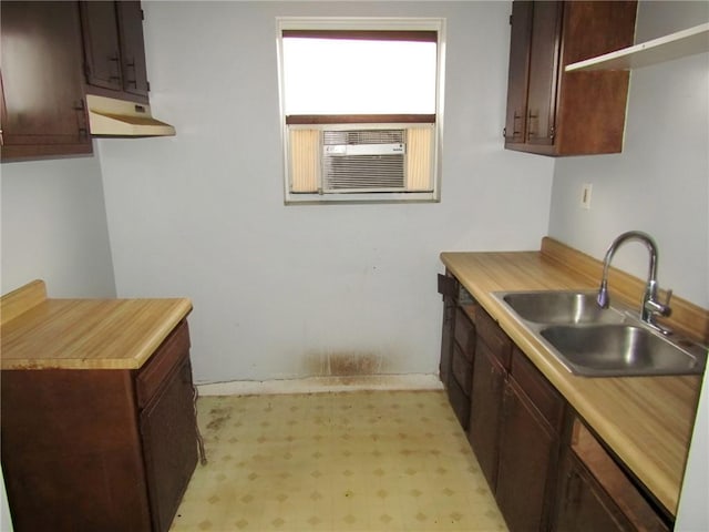 kitchen featuring dark brown cabinetry, sink, and cooling unit