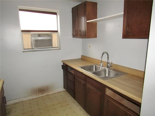 kitchen featuring dark brown cabinetry, sink, and cooling unit