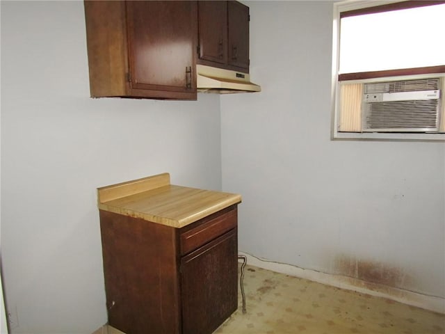 kitchen featuring dark brown cabinets and cooling unit