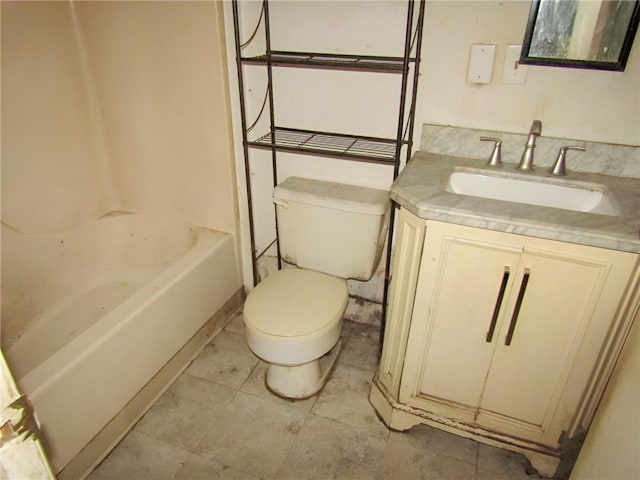 bathroom featuring a washtub, tile patterned floors, vanity, and toilet