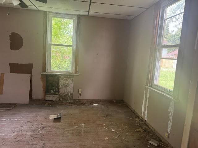 misc room featuring a paneled ceiling, plenty of natural light, and ceiling fan