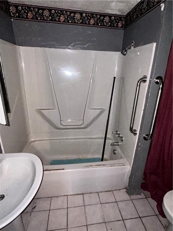 bathroom with tile patterned flooring, toilet, and tub / shower combination