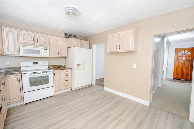 kitchen featuring light hardwood / wood-style floors, white appliances, and a textured ceiling