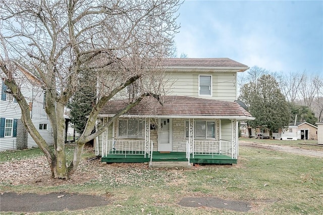 view of front property with covered porch and a front lawn