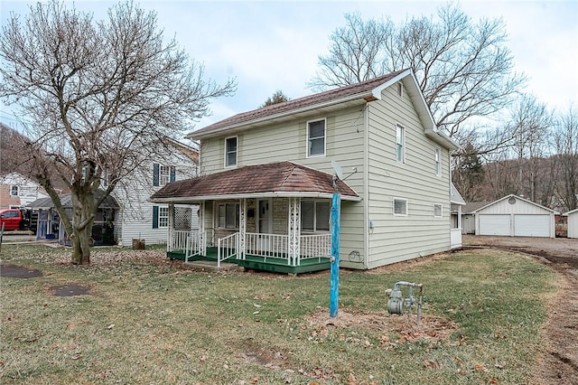 view of front of property featuring a porch, an outbuilding, a front yard, and a garage