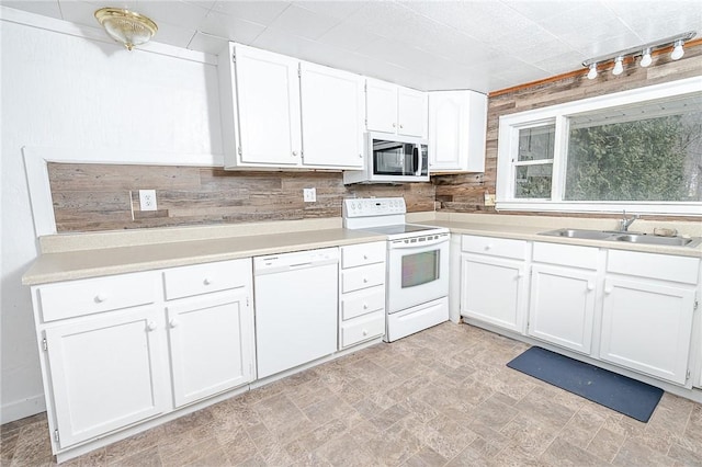 kitchen featuring white cabinetry, sink, tasteful backsplash, track lighting, and white appliances