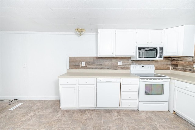 kitchen featuring decorative backsplash, white appliances, and white cabinets