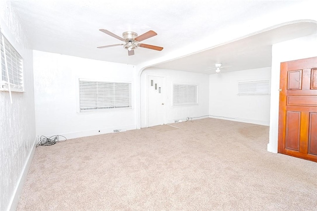 spare room featuring light carpet and ceiling fan