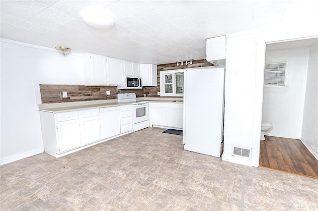 kitchen with decorative backsplash, white cabinetry, and white appliances