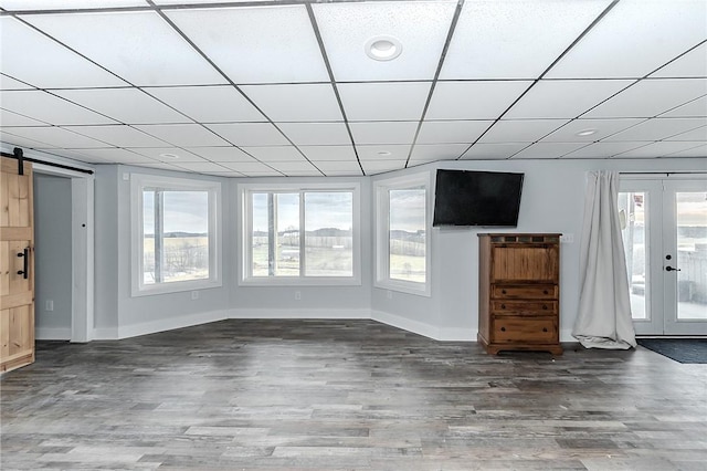 585 State Route 2007, Cowanshanock Twp, PA 16201 - unfurnished living room with wood finished floors, a barn door, and a drop ceiling