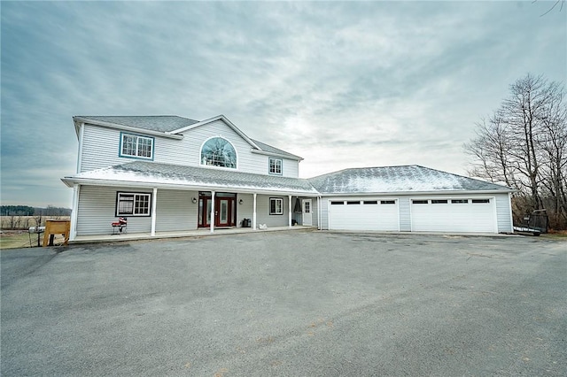 view of front facade with a porch and a garage