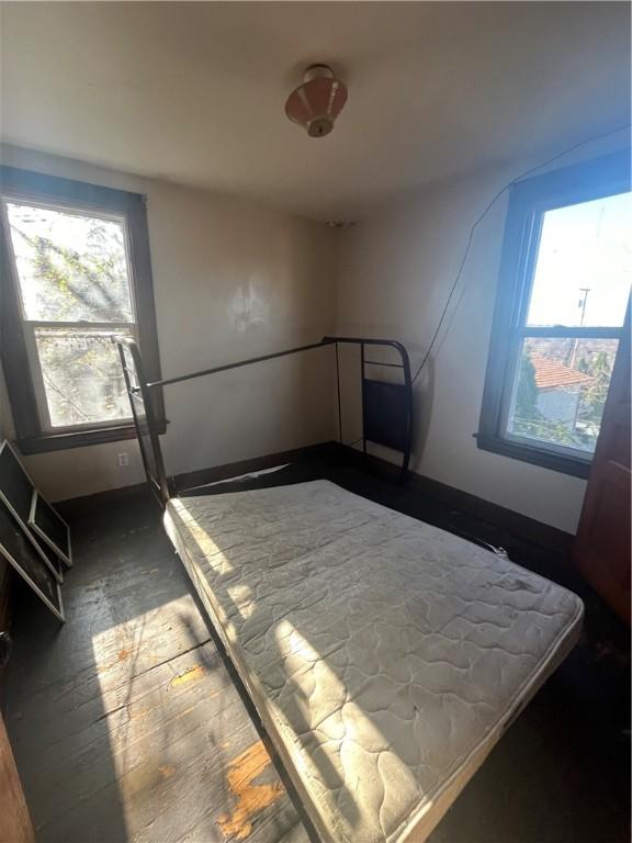 bedroom with dark hardwood / wood-style flooring