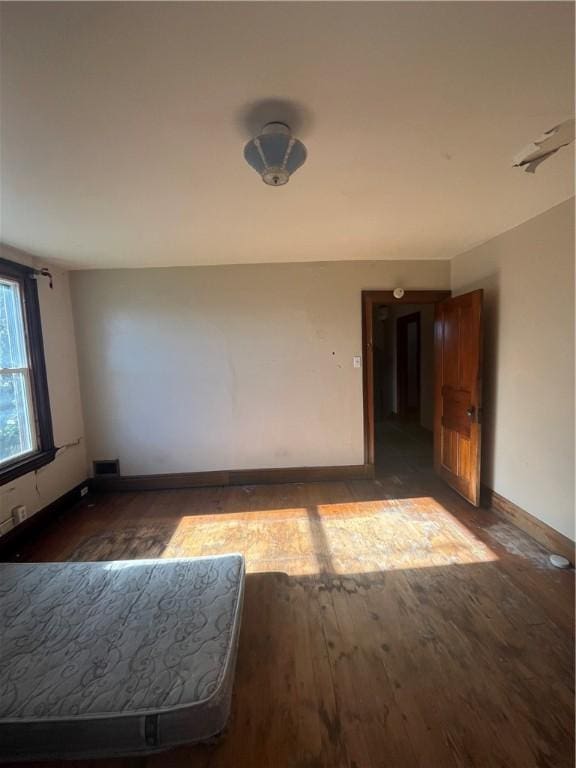 empty room with dark wood-type flooring