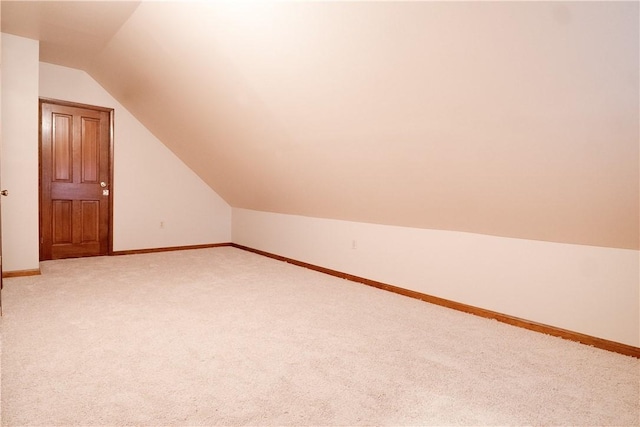 additional living space with carpet flooring and vaulted ceiling