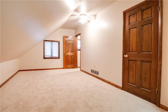 bonus room with ceiling fan, carpet floors, and lofted ceiling