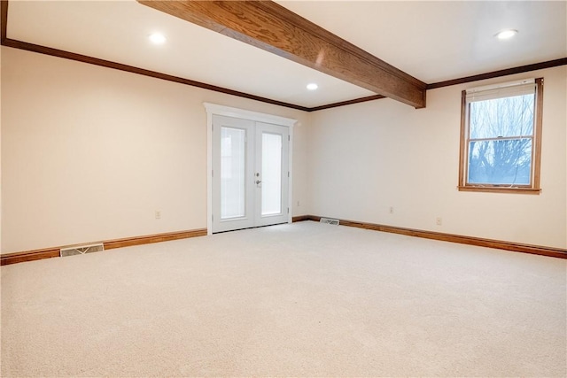 unfurnished room with carpet, french doors, and beamed ceiling