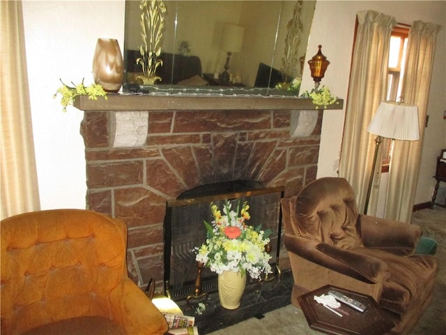 living area with a fireplace and carpet floors