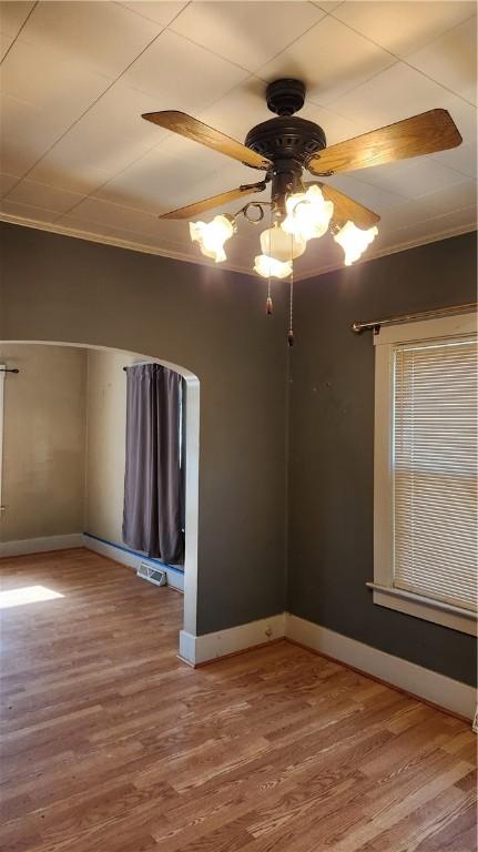 spare room with ceiling fan, hardwood / wood-style floors, and ornamental molding