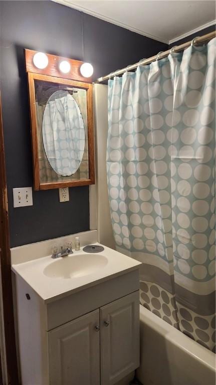 bathroom with shower / bathtub combination with curtain and sink