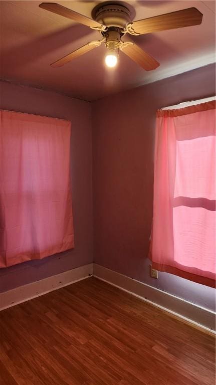 spare room featuring ceiling fan and dark wood-type flooring