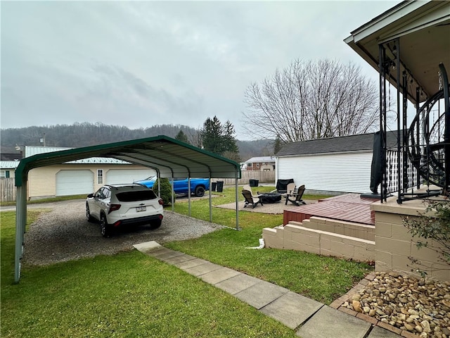 view of yard with a fire pit and a carport