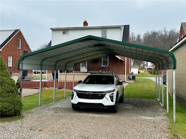 view of vehicle parking featuring a lawn and a carport