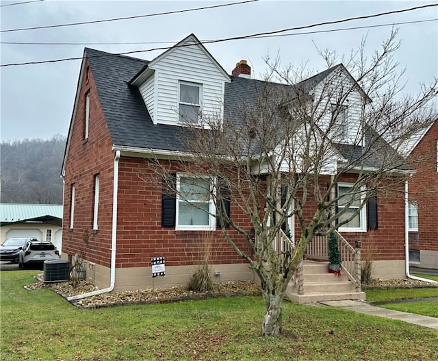 view of front of house featuring a front lawn and central air condition unit