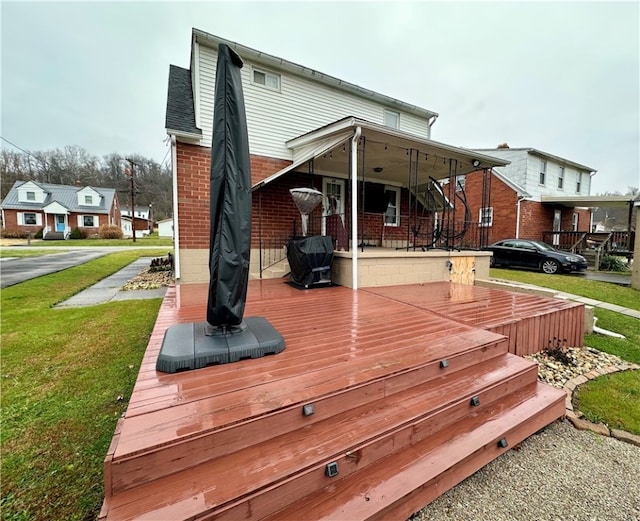 wooden deck featuring a yard