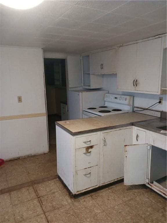 kitchen with white cabinets and white electric range