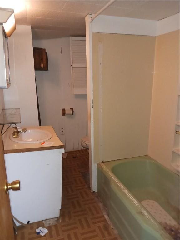 full bathroom with parquet flooring, vanity, toilet, and tub / shower combination