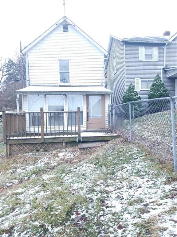 back of house with a wooden deck