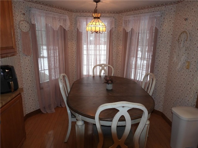 dining area featuring light hardwood / wood-style floors and a notable chandelier