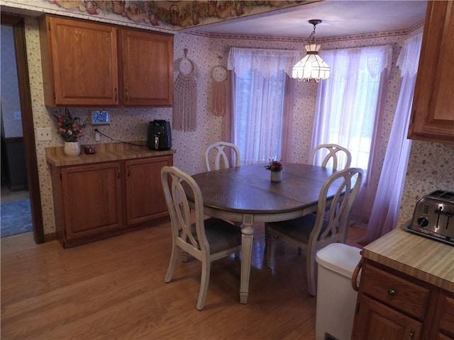 dining room with light hardwood / wood-style flooring and a chandelier