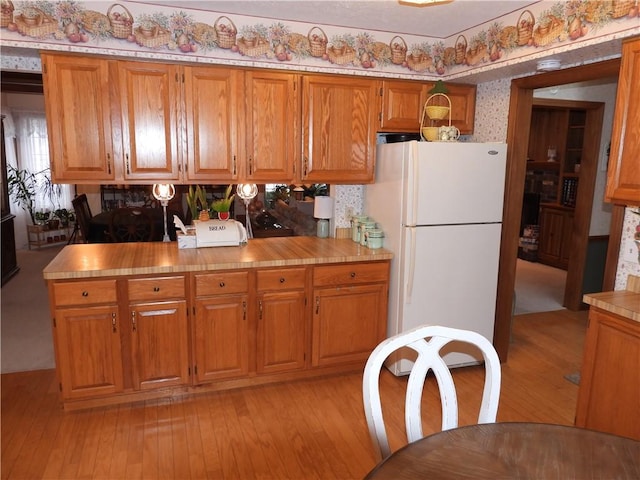 kitchen with white fridge and light hardwood / wood-style floors