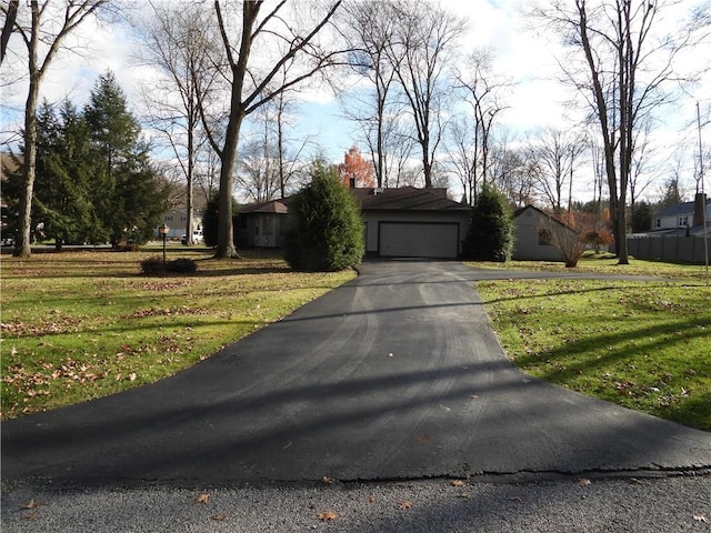 view of front of home with a front lawn and a garage