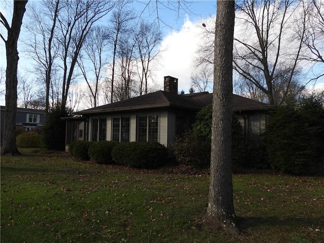 view of home's exterior with a yard