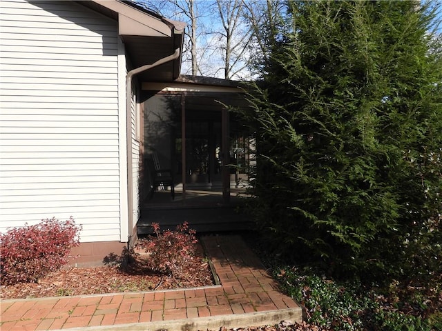 view of property exterior featuring a sunroom